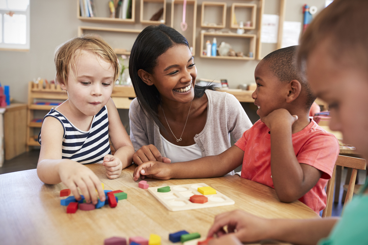 Children engaged in Montessori learning activities at Oak Grove